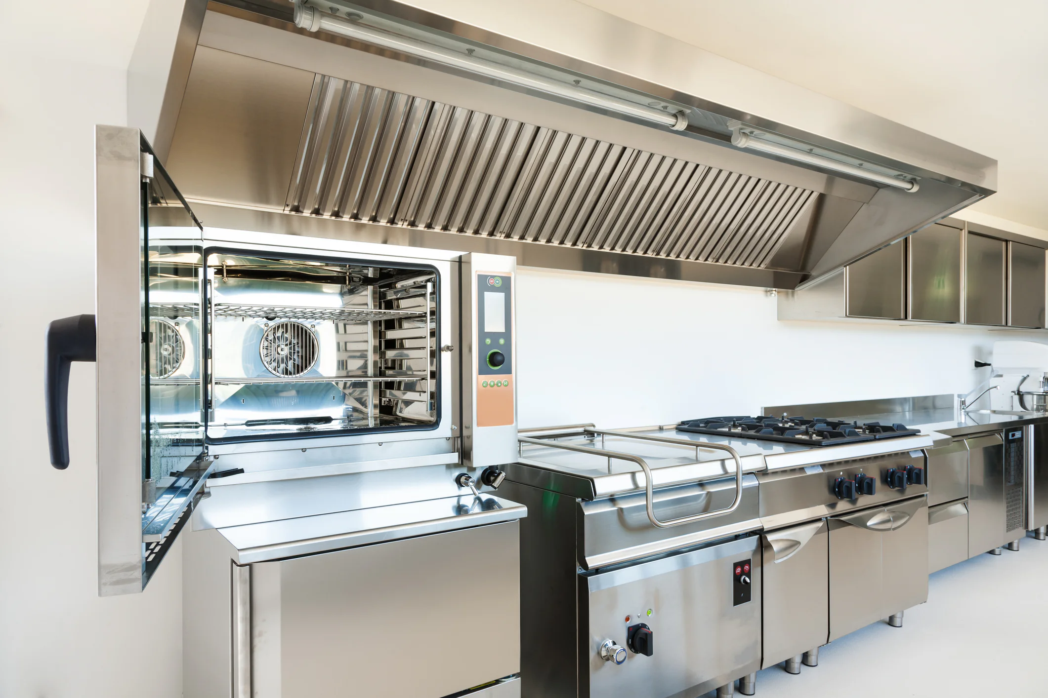 Technician performing commercial kitchen exhaust hood repair