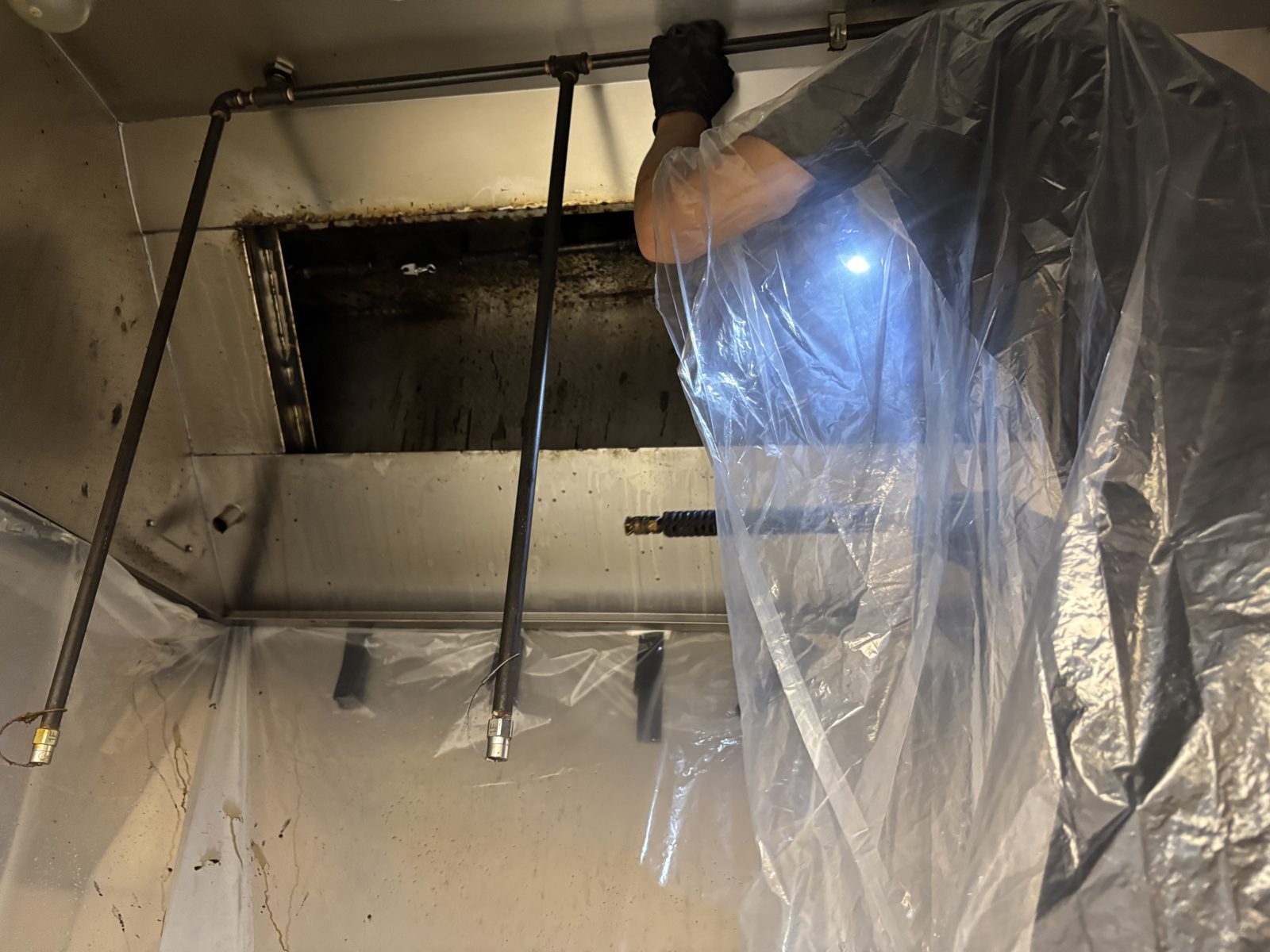 Inside a commercial kitchen hood plenum during an El Paso hood cleaning