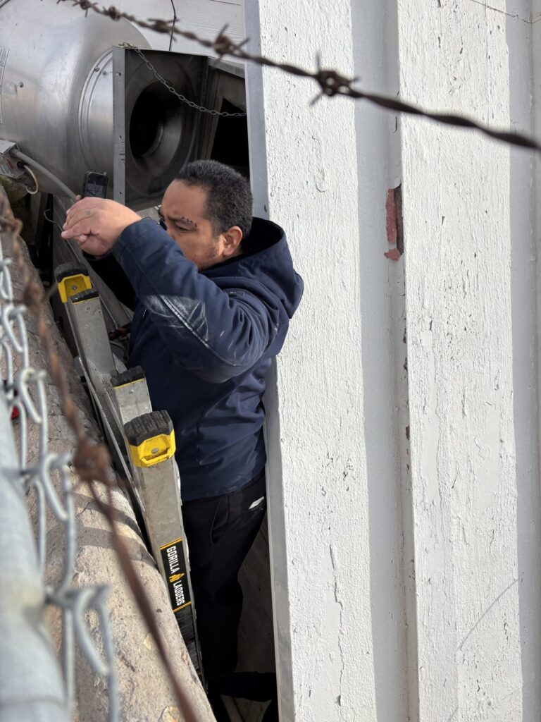 Kitchen Guard of El Paso technician servicing a rooftop exhaust fan