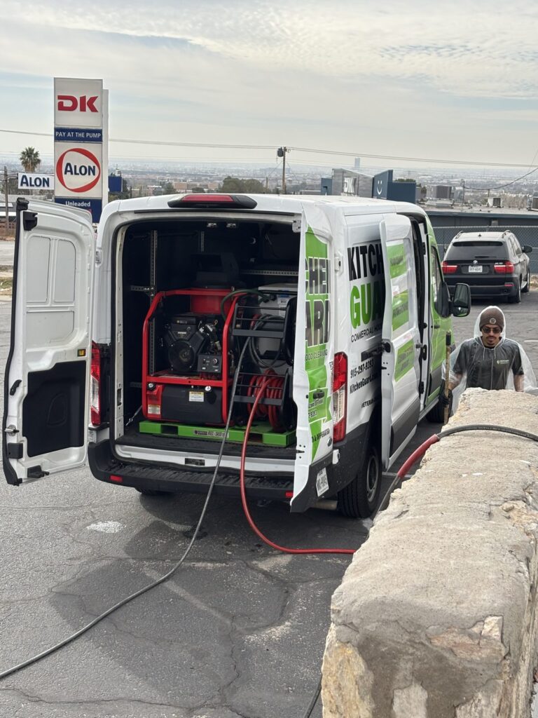 Kitchen Guard of El Paso pressure washing rig in a service van with the El Paso skyline behind