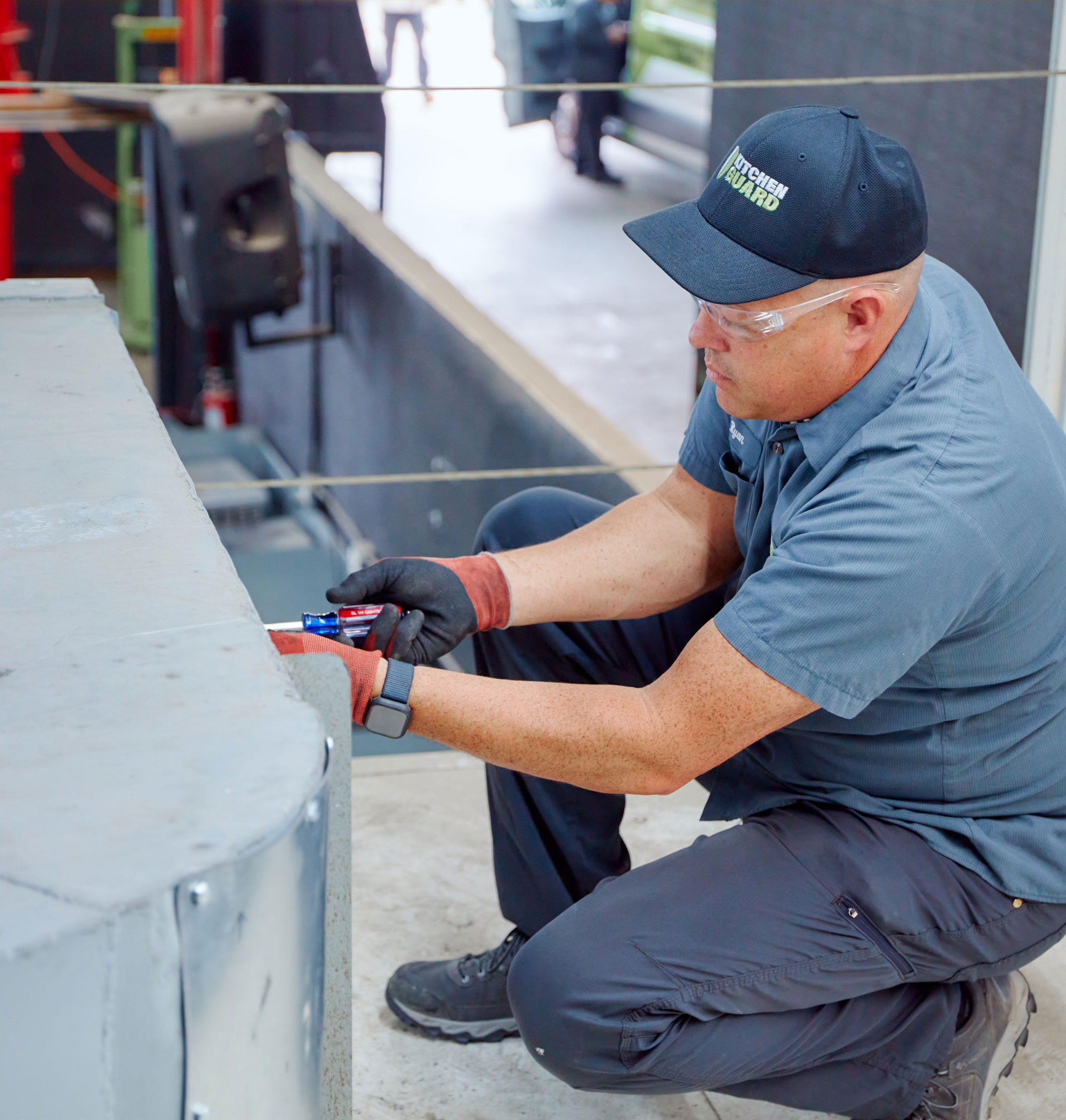 Kitchen Guard technician servicing a commercial kitchen exhaust fan in Greenville, SC