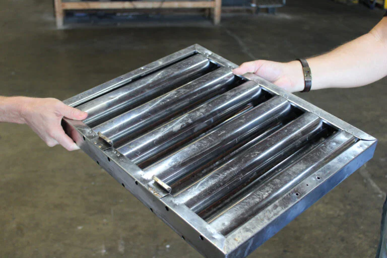 Grease-laden baffle filter removed from a commercial kitchen hood during a filter exchange