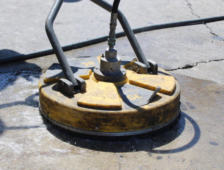 Commercial pressure washing surface cleaner nozzle on concrete