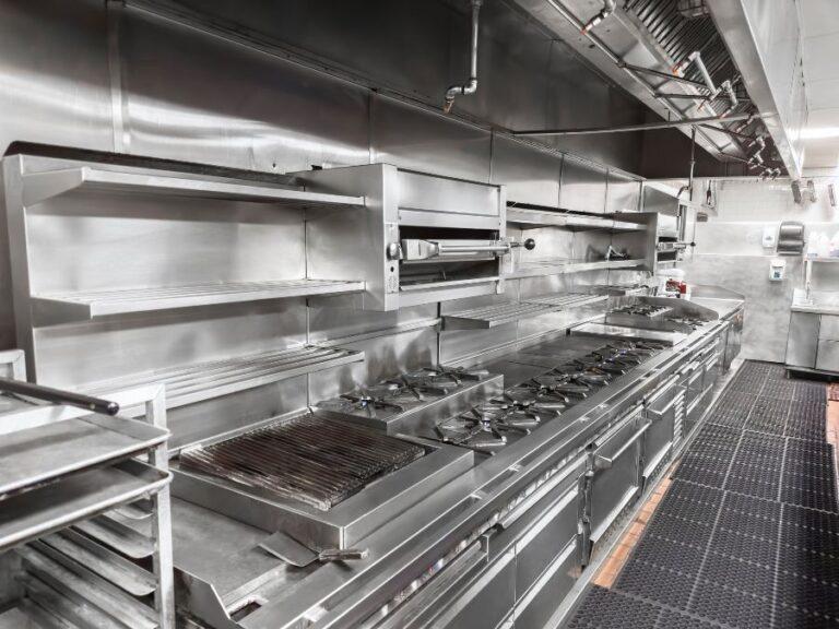 Stainless steel commercial kitchen exhaust hood and cook line in a Phoenix restaurant