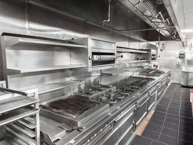 Stainless steel commercial kitchen exhaust hood and cook line in a Phoenix restaurant