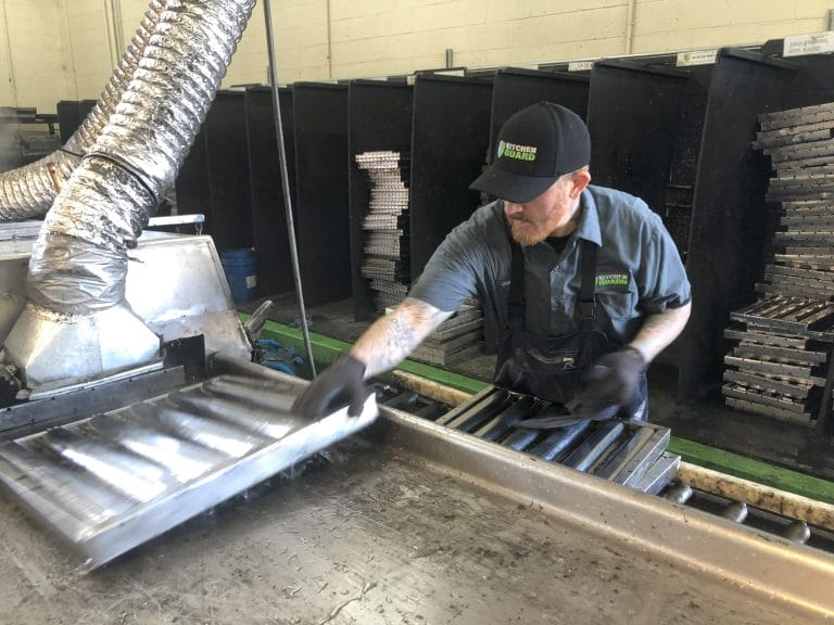 image of a Kitchen Guard employee cleaning commercial kitchen filter